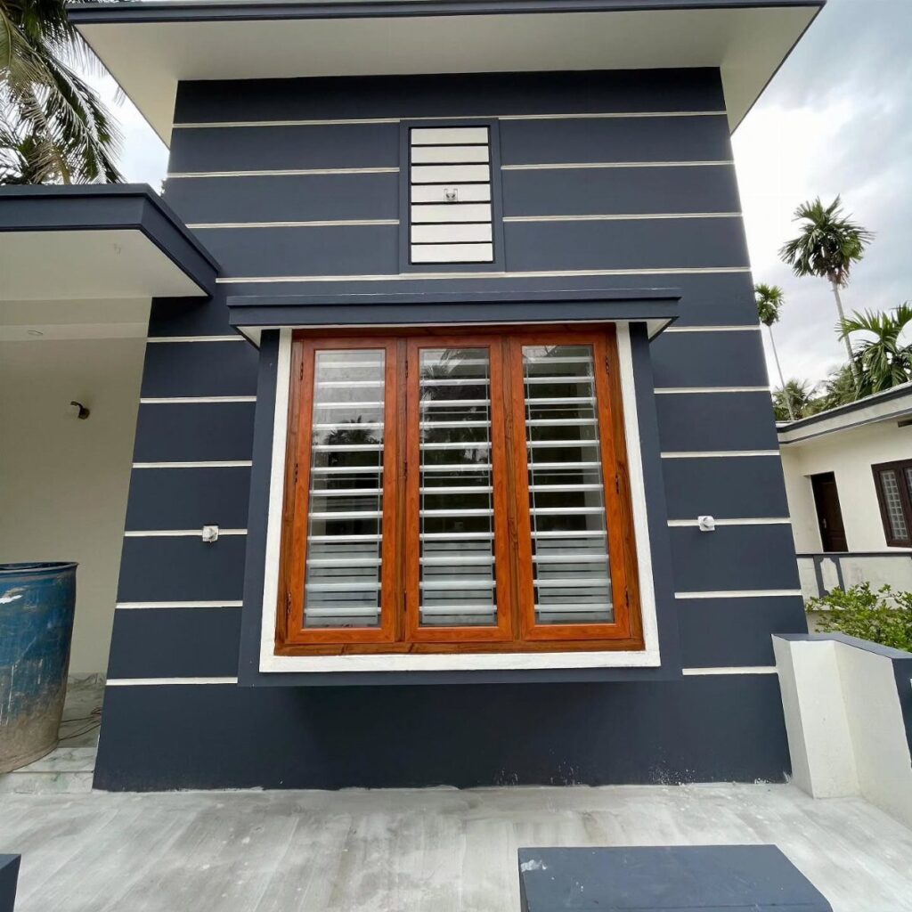 A dark grey wall with white horizontal stripes and a large wooden louvered window.